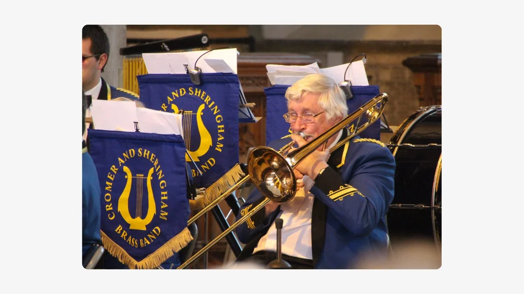 An older man plays a trombone in a band. Credit: Jane Bussey.